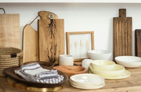 Wood table filled with artisan made bowls and cutting boards