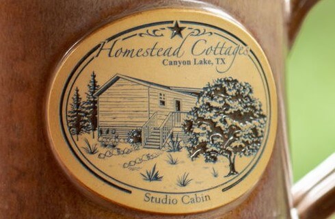Close up of coffee mug with cabin logo.