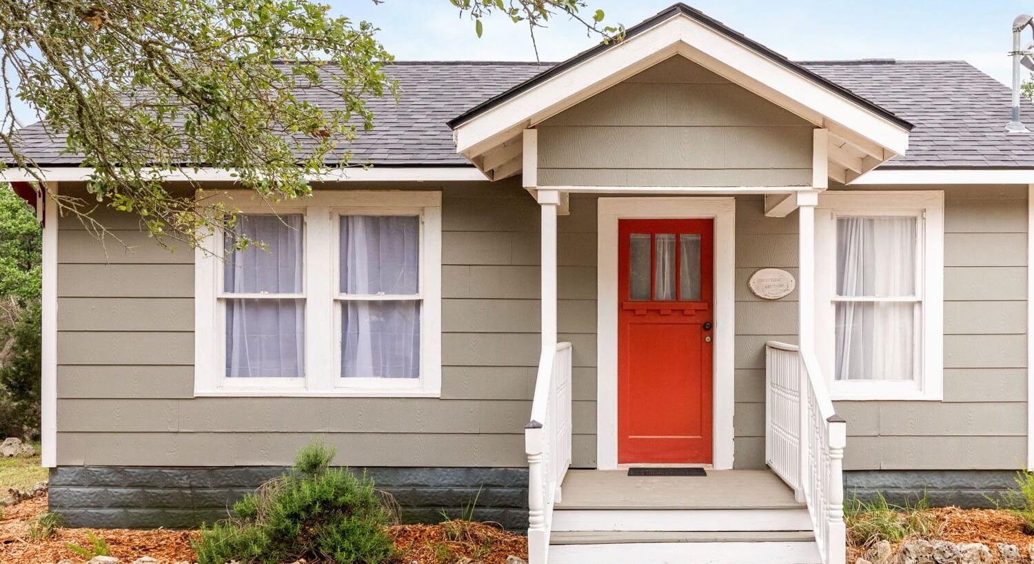 Exterior of a house with a red door.