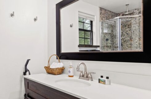 Bathroom area of a cabin with a mirror and sink.