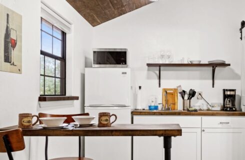 Kitchen with wood table and coffee cups.