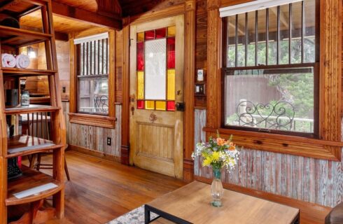 Ships ladder leading to the loft area and a front door with stained glass.