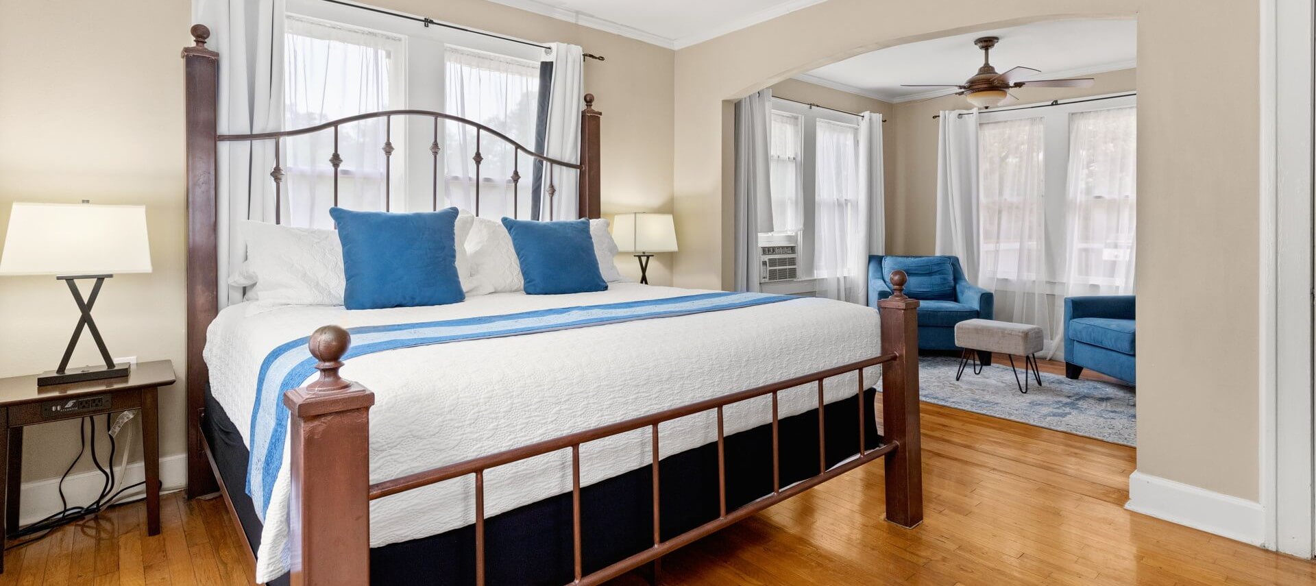 Two glasses of golden beer on the edge of a bubbling hot tub by a cabin