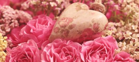 Image of a pink heart surrounded by roses.